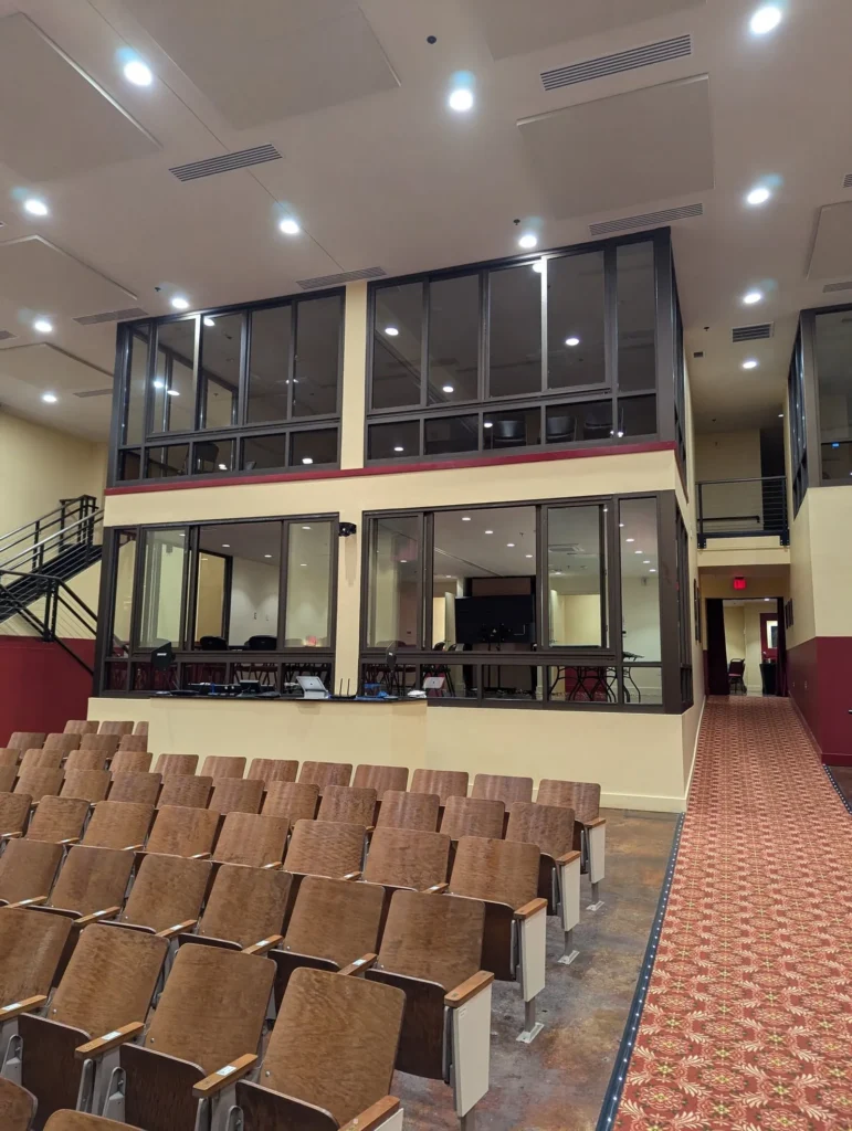 Glass-walled rooms above the back of the auditorium